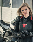 A blond woman wearing Black and red women's motorcycle racing suit from Shima