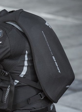 A person&#39;s back wearing black motorcycle backpack 
