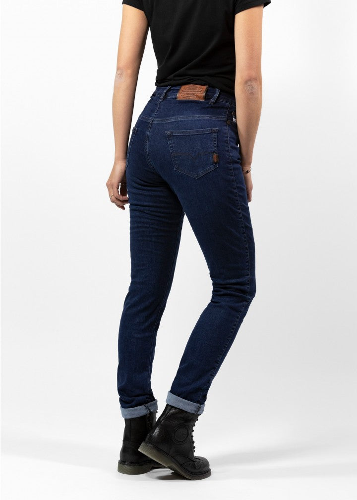 Woman&#39;s legs from the back wearing dark blue high waisted women&#39;s motorcycle jeans from JohnDoe