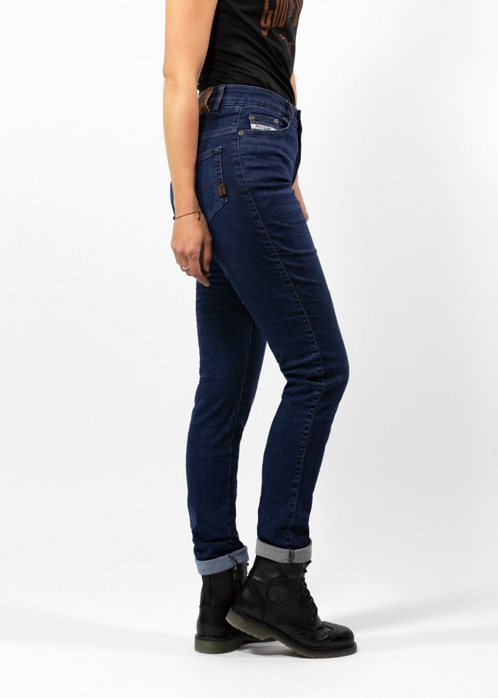 Woman&#39;s legs from the side wearing dark blue high waisted women&#39;s motorcycle jeans from JohnDoe