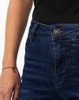 A close up of the button of Woman's legs wearing dark blue high waisted women's motorcycle jeans from JohnDoe