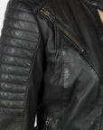 A shoulder close up of the Women's black leather motorcycle jacket modern classic style from Black arrow label