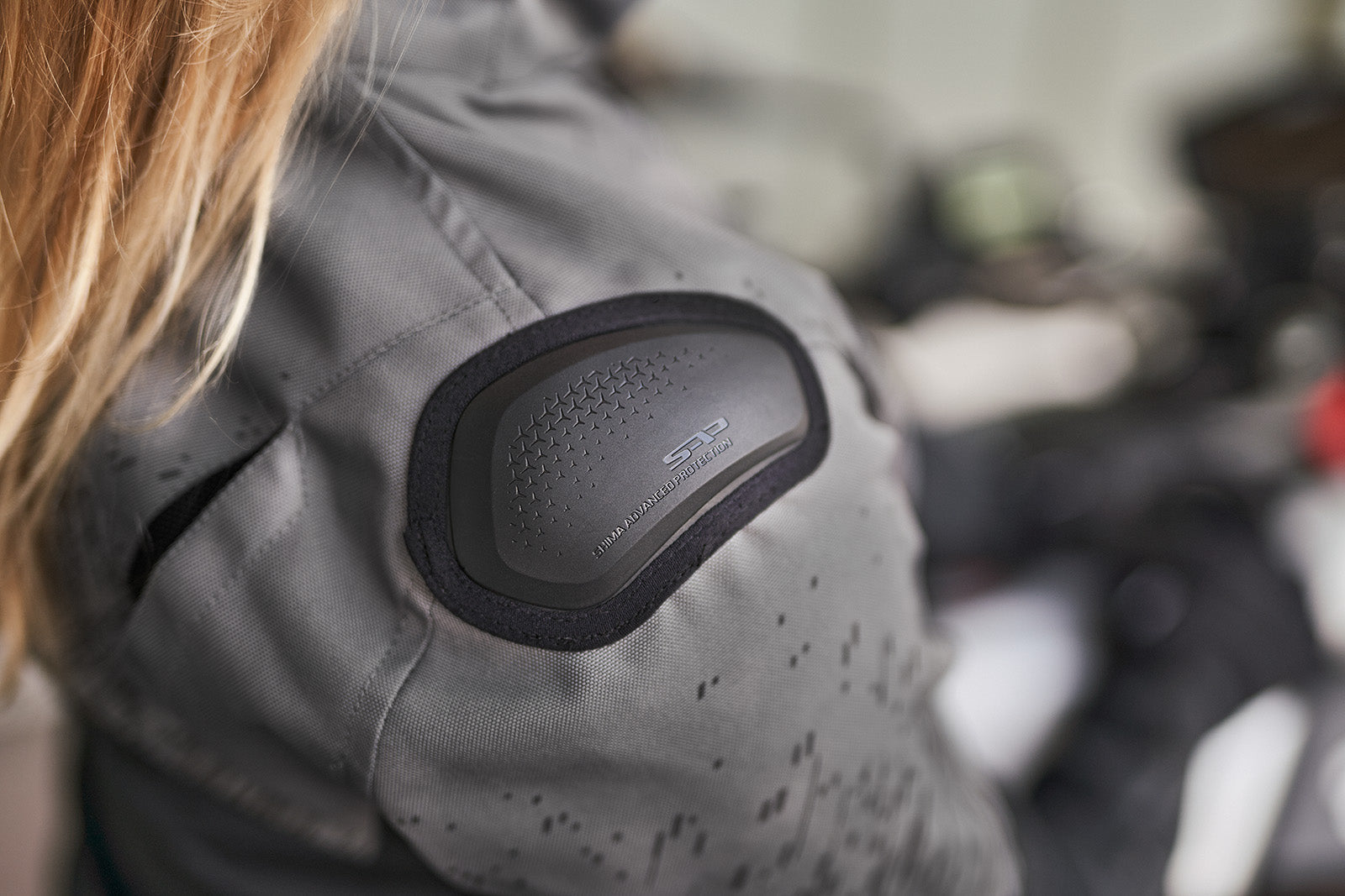 a slider on the shoulder of grey women&#39;s motorcycle jacket from SHIMA