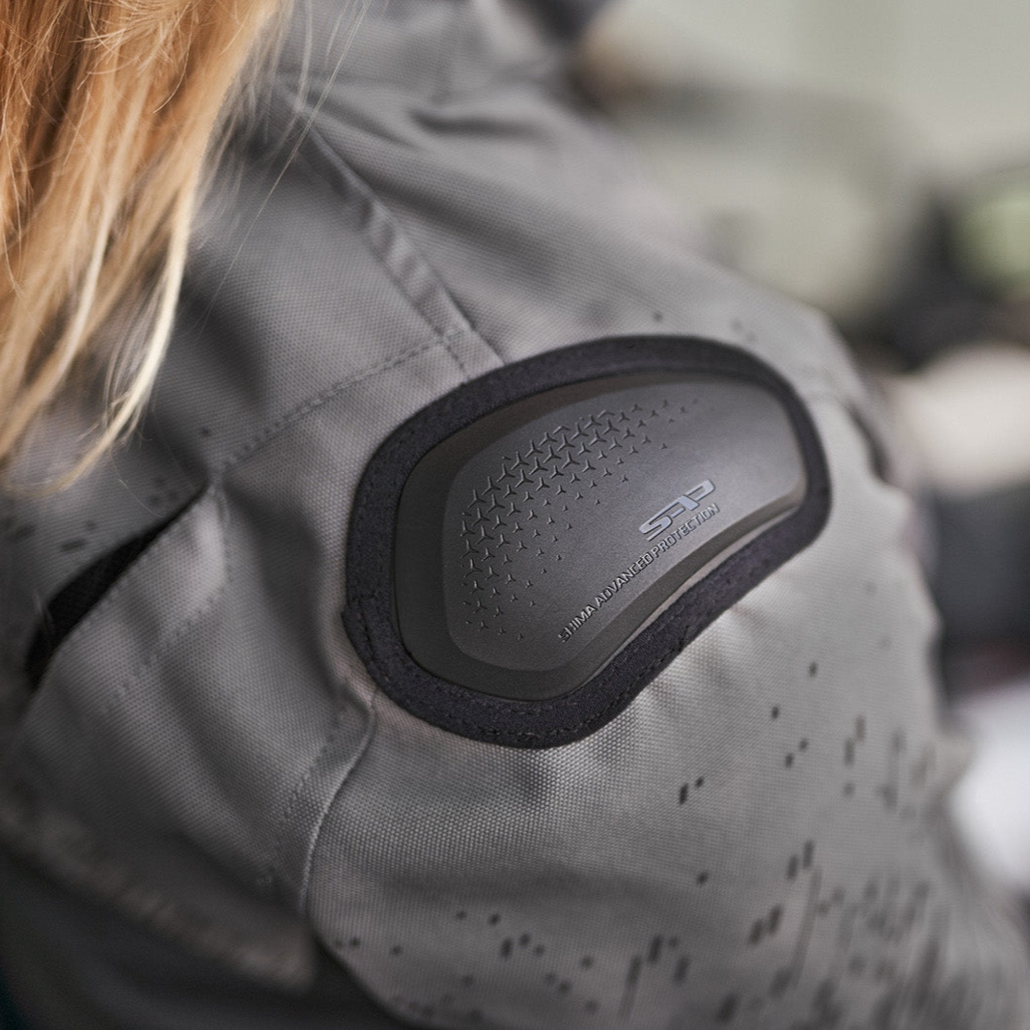 a slider on the shoulder of grey women&#39;s motorcycle jacket from SHIMA