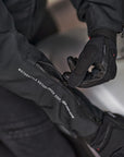 Woman's hands zipping the sleeve of the motorcycle jacket