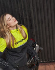 Blond young woman wearing fluo color motorcycle jacket from SHIMA