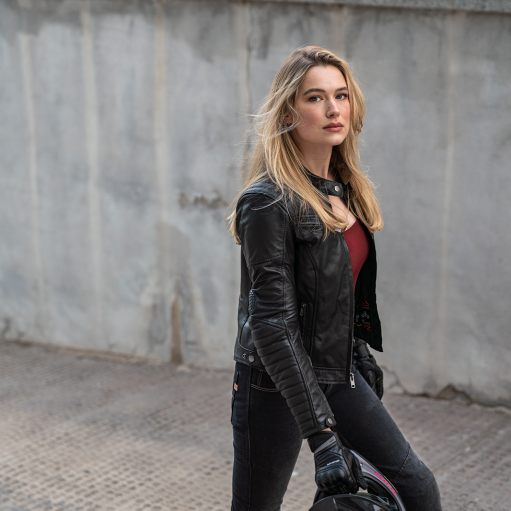 A blond woman  wearing Black leather motorcycle jacket for women from Shima