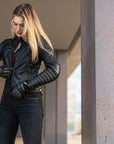 A blond woman wearing Black leather motorcycle jacket for women from Shima
