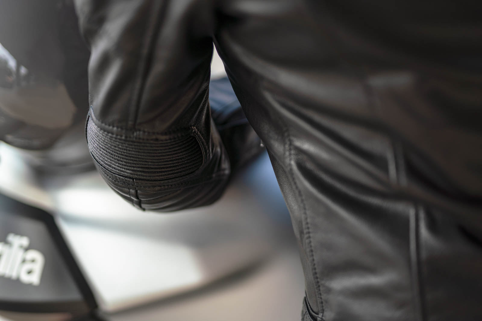 A close up of a sleeve of women&#39;s leather motorcycle jacket