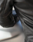 A close up of a sleeve of women's leather motorcycle jacket