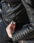 A close up of a stud on the leather motorcycle jacket