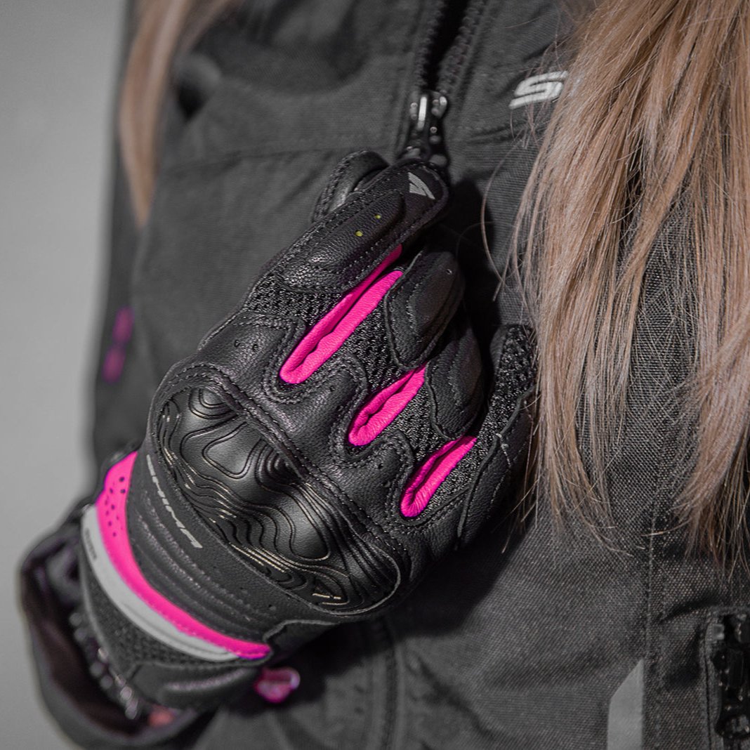 A close up of a woman&#39;s hand wearing Black and pink women&#39;s motorcycle gloves Rush lady  from Shima