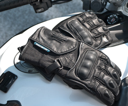  black waterproof motorcycle gloves on a white motorcycle  tank 