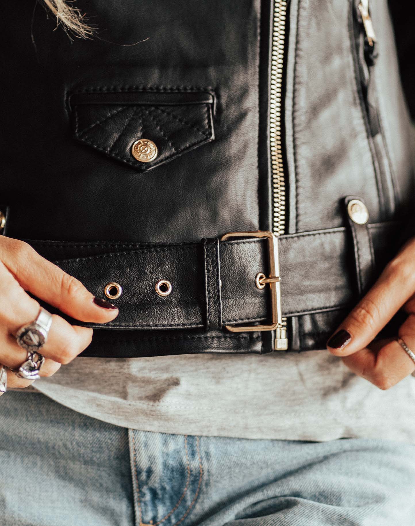 A close up of the belt on the Classic retro black women&#39;s motorcycle jacket from Eudoxie