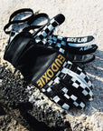 Black and white chessboard motives women's leather motorcycle gloves from Eudoxie on the ground