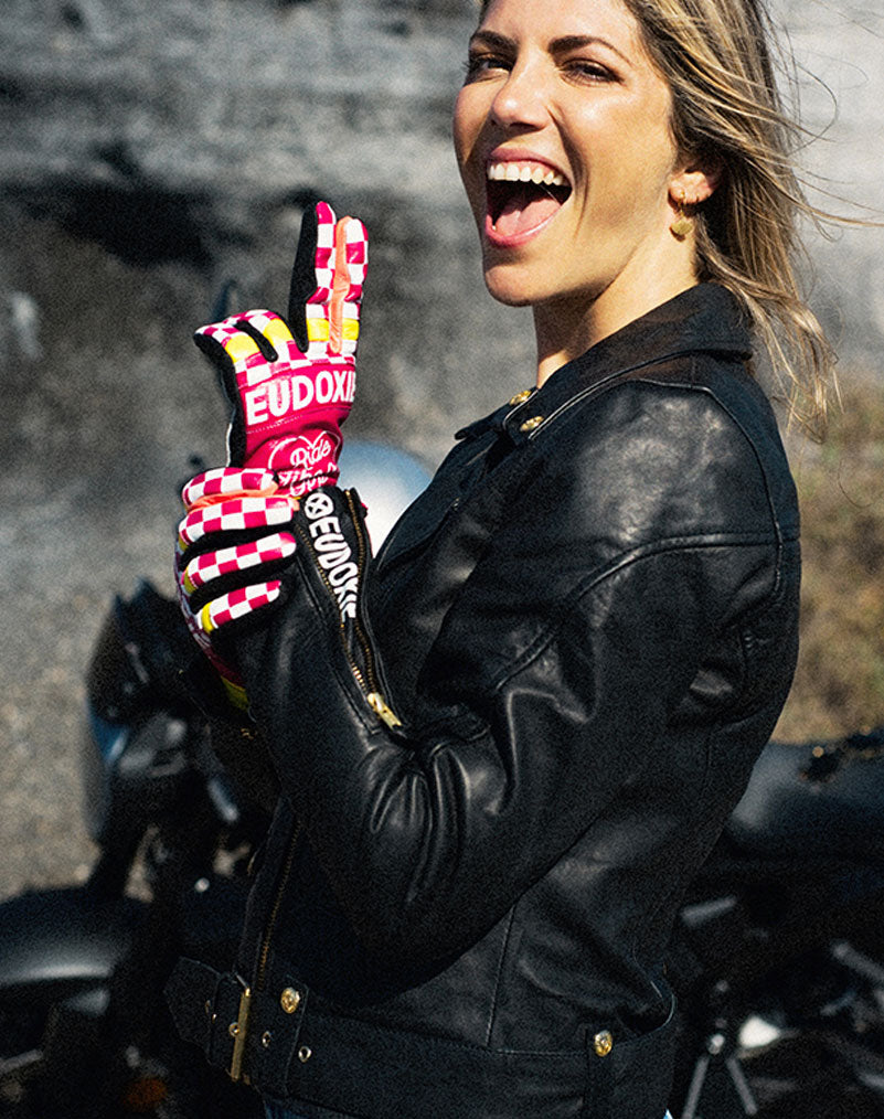A woman wearing Ride like a Girl pink, black and yellow women&#39;s motorcycle gloves from eudoxie