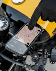 A phone mounted on a motorcycle handlebar