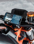 A phone mounted on the motorcycle handlebar