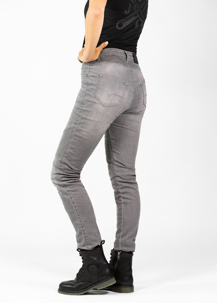 Woman&#39;s legs from the side wearing light grey women&#39;s motorcycle jeans from JohnDoe