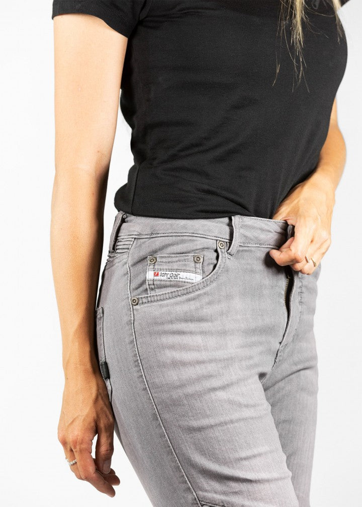 A close up of a woman&#39;s waist  wearing light grey women&#39;s motorcycle jeans from JohnDoe