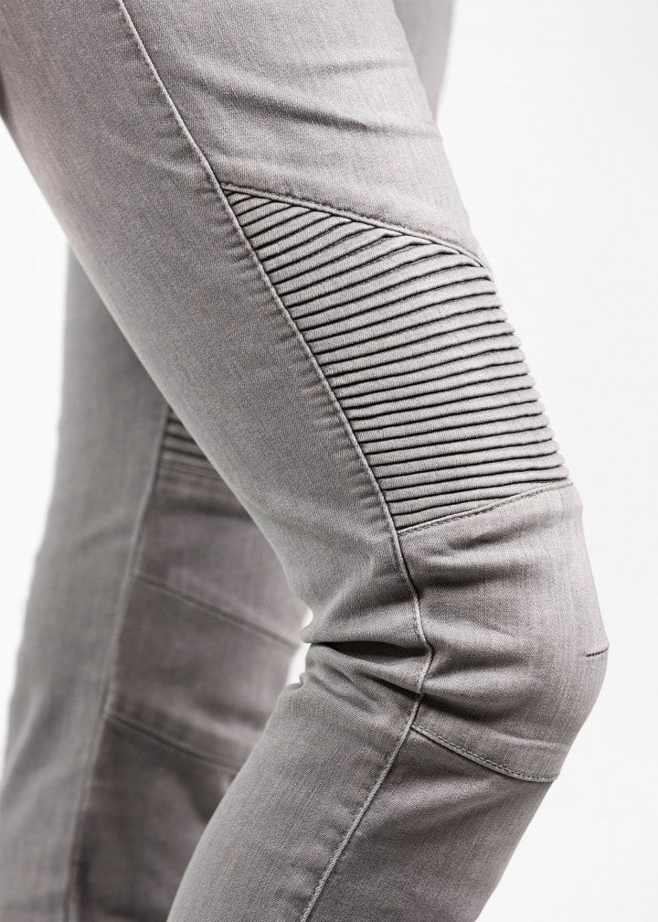 A close up of a woman&#39;s knee wearing light grey women&#39;s motorcycle jeans from JohnDoe