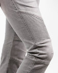 A close up of a woman's knee wearing light grey women's motorcycle jeans from JohnDoe