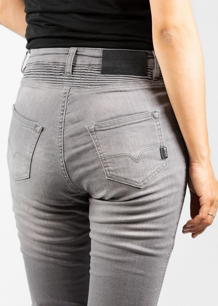 A close up of a woman&#39;s back wearing light grey women&#39;s motorcycle jeans from JohnDoe