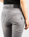 A close up of a woman's back wearing light grey women's motorcycle jeans from JohnDoe
