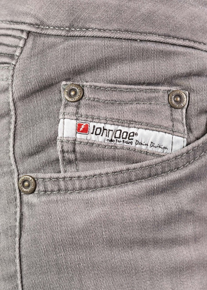 A close up of the John Doe logo on the light grey women&#39;s motorcycle jeans 