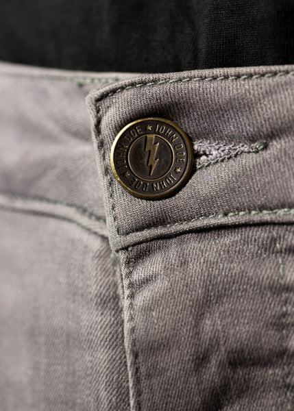 A close up of the jeans button on the light grey women's motorcycle jeans from John Doe