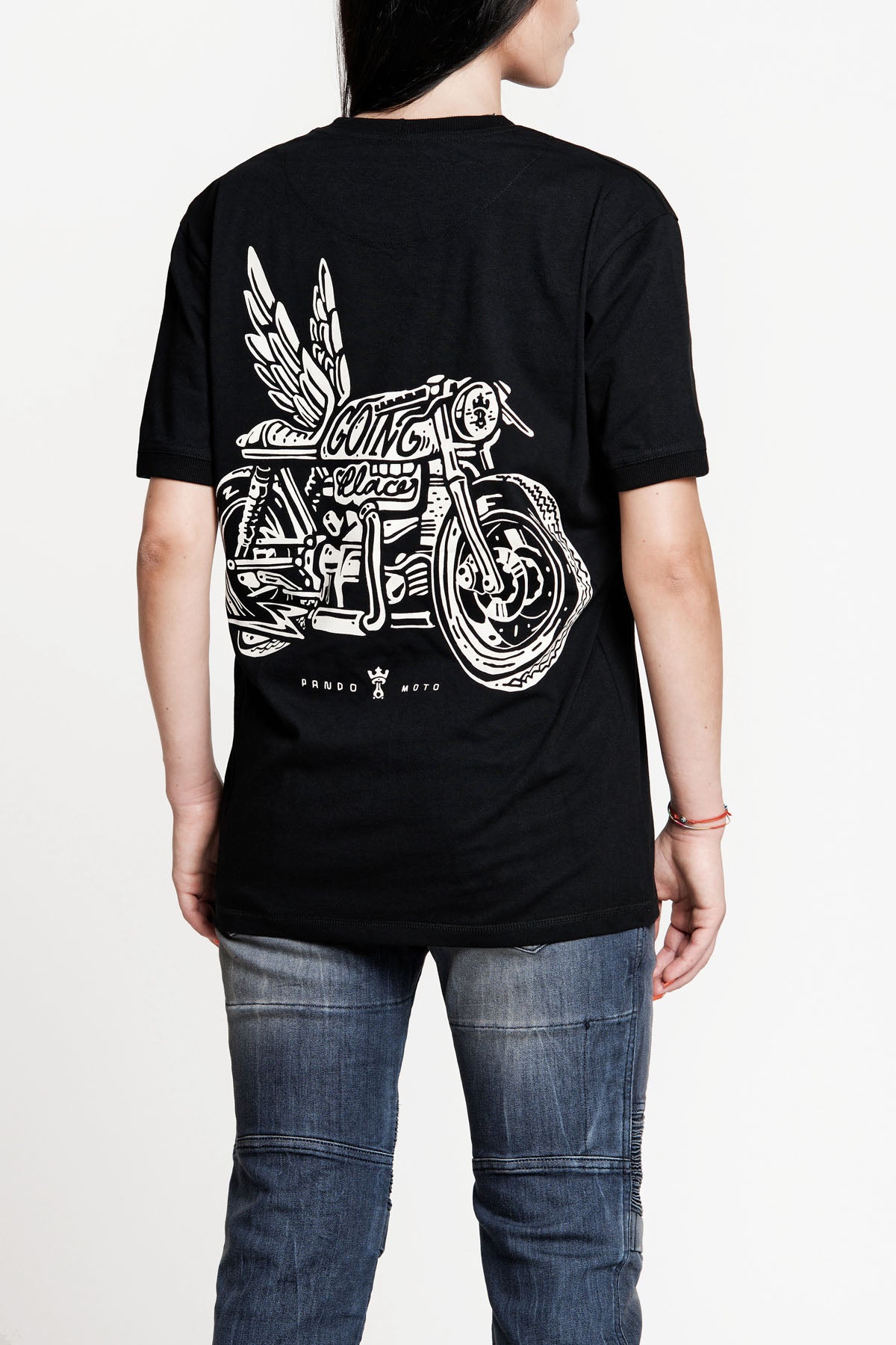 A woman wearing Pando Moto motorcycle t-shirt with the picture of a motorcycle with wings and title that says &quot;going places&quot;