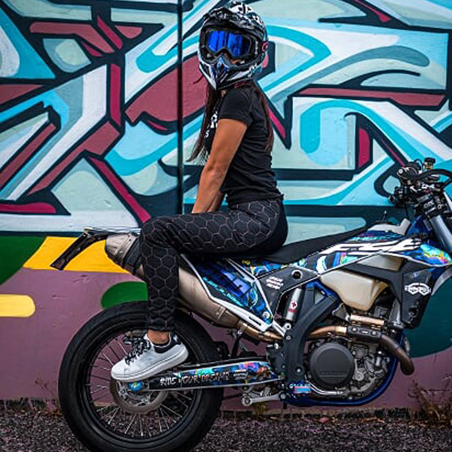 A woman wearing black and pink sewed women&#39;s motorcycle leggings from exagon66