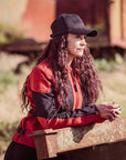 a  woman with the cap wearing red and black women's motorcycle summer jacket from Moto Girl 