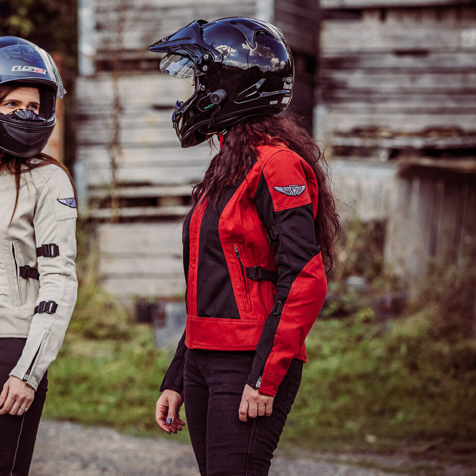 Two women with helmets on  wearing red and white women&#39;s motorcycle summer jackets from Moto Girl 