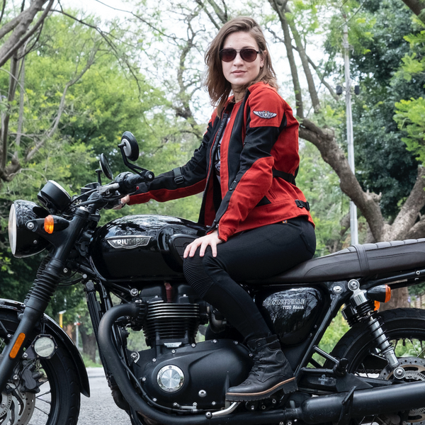 a young woman on a Triumph motorcycle wearing red and black women's motorcycle summer jacket from Moto Girl 