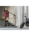 A women walking away from her motorcycle and wearing Thomason black motorcycle boots from Shima