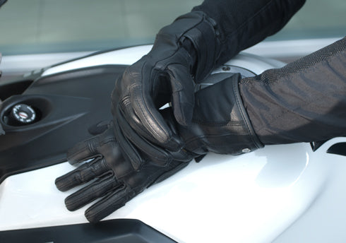 Woman&#39;s hands on the motorcycle wearing Long leather black women&#39;s motorcycle glove